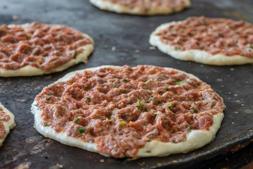 Preparing pita with lamb meat and chives