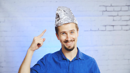 Paranoid man with a conspiracy foil hat