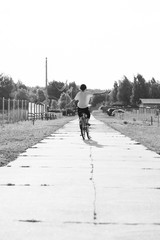 Happy girl rides a classic bike among beautiful nature.