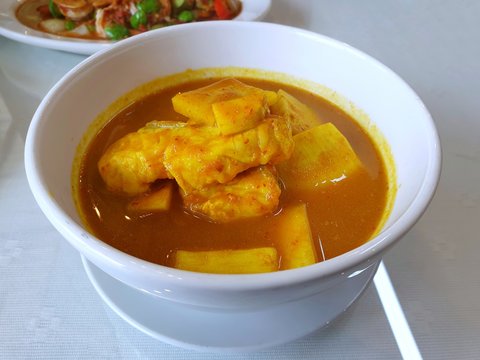 Thai food style,Top view sour soup with snapper and young coconut shoots in white bowl on table at restaurant ready to eat or served, This food is most popular