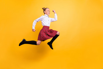 Full length body size view of her she nice lovely attractive cheerful cheery strong pre-teen girl running fast isolated over bright vivid shine yellow background