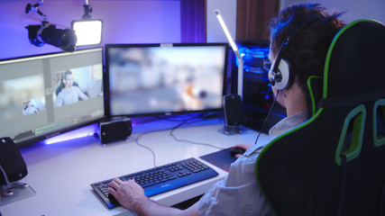 Gamer streaming and playing game on computer
