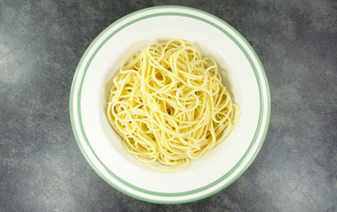 Yellow long spaghetti on stone background, Yellow italian pasta. Food background concept, Blank for design.