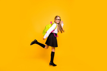 Full length body size view of her she nice attractive cheerful cheery glad straight-haired pre-teen girl having fun going to first grade isolated on bright vivid shine yellow background