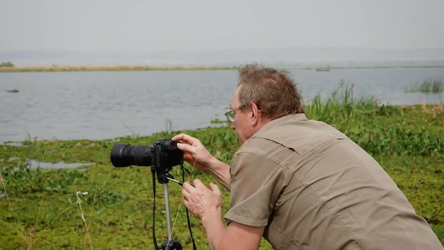 Photographer Takes Video Of Wildlife Of Africa On Camera Standing On Tripod
