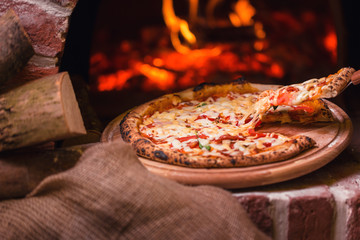 tasty pizza out of oven in restaurant kitchen