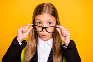 Close up photo of astonished kid looking wear bag backpack rucksack isolated over yellow background