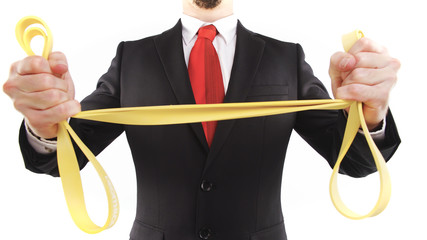 Headless businessman stretching rubber band