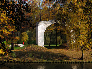 Early sunny autumn trees and a brick arch in the park of Tsaritsyno in Moscow
