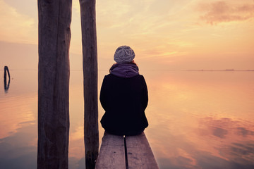 On a pier during a beautiful sunset on the island of Burano near Venice, Italy.