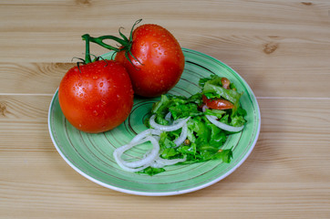  fresh tomatoes with salad on a plate