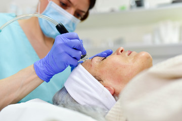Obraz na płótnie Canvas Woman receiving Hydrodermabrasion Facial therapy
