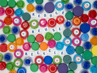 Plastic bottle caps of many colors, recycling concept