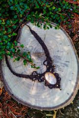 Macrame necklace with natural mineral gemstone on natural background