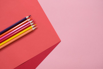 Fototapeta premium Abstract geometric paper background with color pencils. School and education concept.