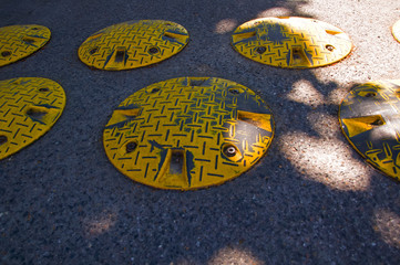 Yellow speed bumps on the road, summer