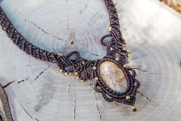 Macrame necklace with natural mineral gemstone on natural background