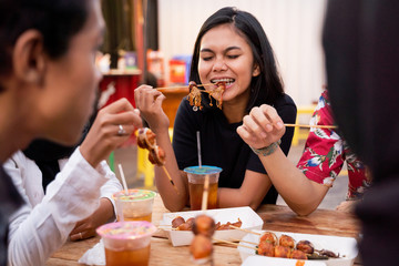 Young people lunch together when hanging out on the rooftop outdoor foodcourt
