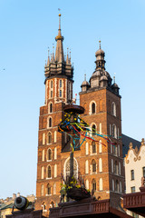 Fototapeta na wymiar Krakow, Poland - April, 2019: Church of St. Mary and the Cloth Hall on the main market square in Krakow