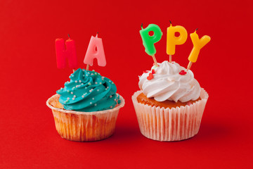 Happy birthday cupcakes on bright colored background