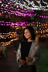 happy young woman enjoy standing near the lamp tumblr at the night