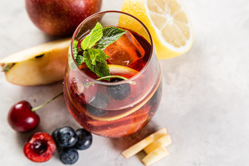 Selection of sangrias - red, pink, white and ingredients, rustic background
