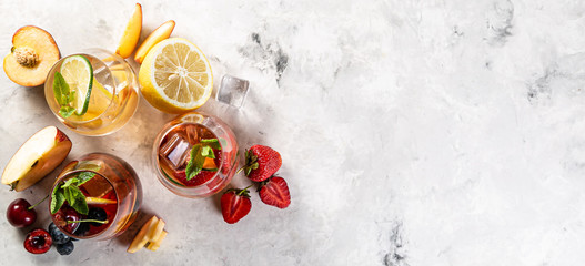 Selection of sangrias - red, pink, white and ingredients, rustic background