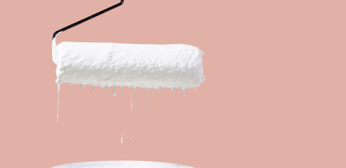 The paint roller has white drops on green background.