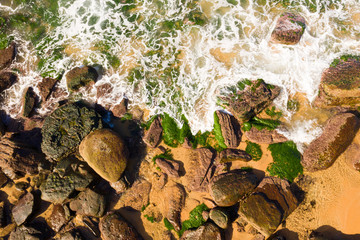 Low tide showing rocks and green seaweed interesting texture 
