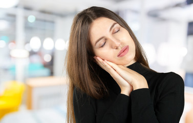 Caucasian lady pretending to be asleep. Young woman showing sleep gesture