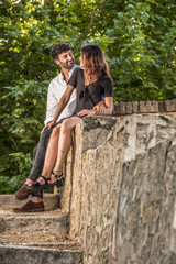 Portrait of a young couple in love enjoying in a city park