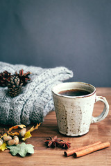 coffee cup on the autumn fall leaves and wooden surface background