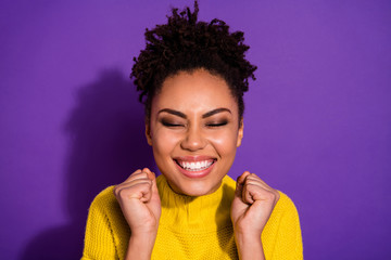 Close up photo of delighted person people raise fists close eyes wear yellow jumper sweater...