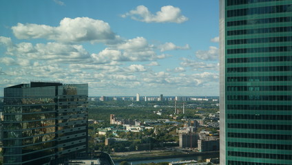 View of Moscow cityscape, a mixture of buildings against the cloudy blue sky