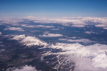 Fototapeta premium Aerial view of snow covered Alps mountains with the Mont-blanc mountain on the background. France 2019.