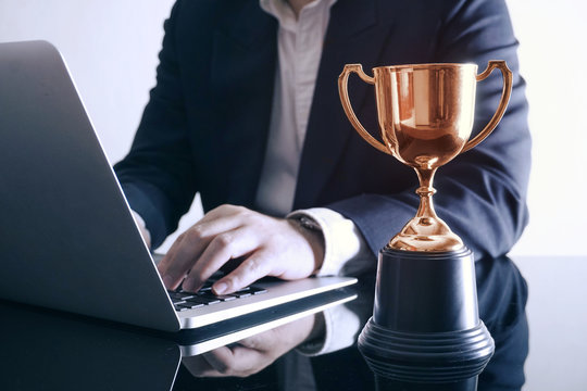 Trophy on working table, achive business concept.