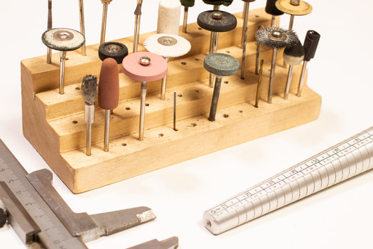 Different goldsmiths tools on the jewellery workplace. Jewelry polishing discs.