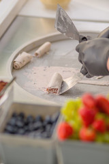 Background process of preparing Ice Cream on a special refrigerator in the Summer with Fruit for a Party to an Event for Children or a Wedding