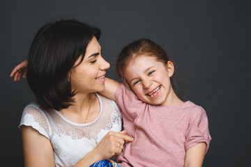 mother tickling daughter