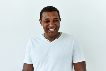 Obraz premium African American man portrait against white background. Laughter and joy emotions