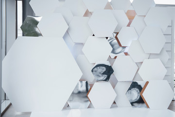 Abstract wall with white pieces of surface in the shape of hexagon in the auto saloon