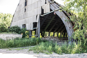 Fototapeta na wymiar Old dilapidated metal production hangar