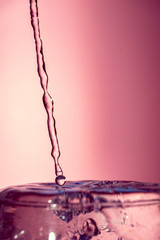 Water splash isolated on pink background, water bubble, detailed picture, natural elements.