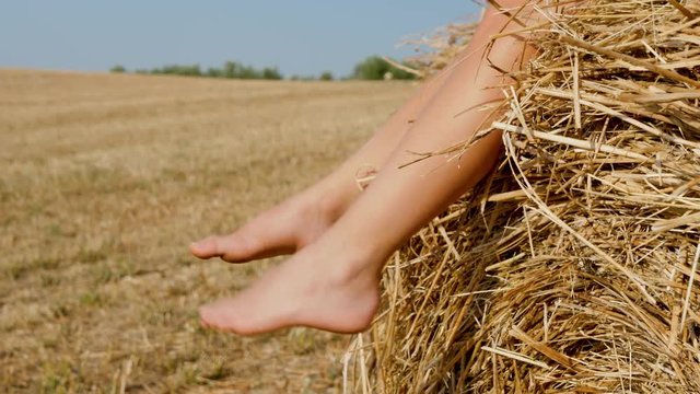 pied d'enfant sur une botte de paille- vid&eacute;o 4k, slow motion
