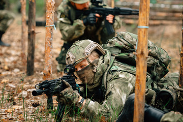 Soldiers in a combat situation. Men play airsoft.