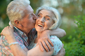 Beautiful senior couple hugging in the park