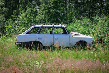 Old rusty Soviet car Muscovite abandoned in the woods