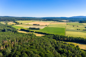 Fototapeta na wymiar Aerial photograph, Agricultural area, Meadows, fields of cereals, villages, fields, forests. Wetterau, Hochtaunuskreis, Hesse, Germany