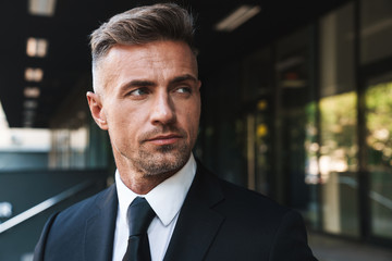 Portrait closeup of handsome businessman standing outside job center during working meeting