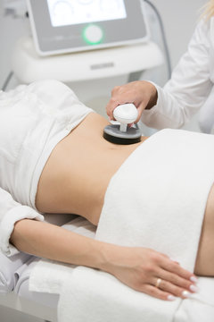 Slim woman getting anticellulite and anti fat therapy in beauty salon
